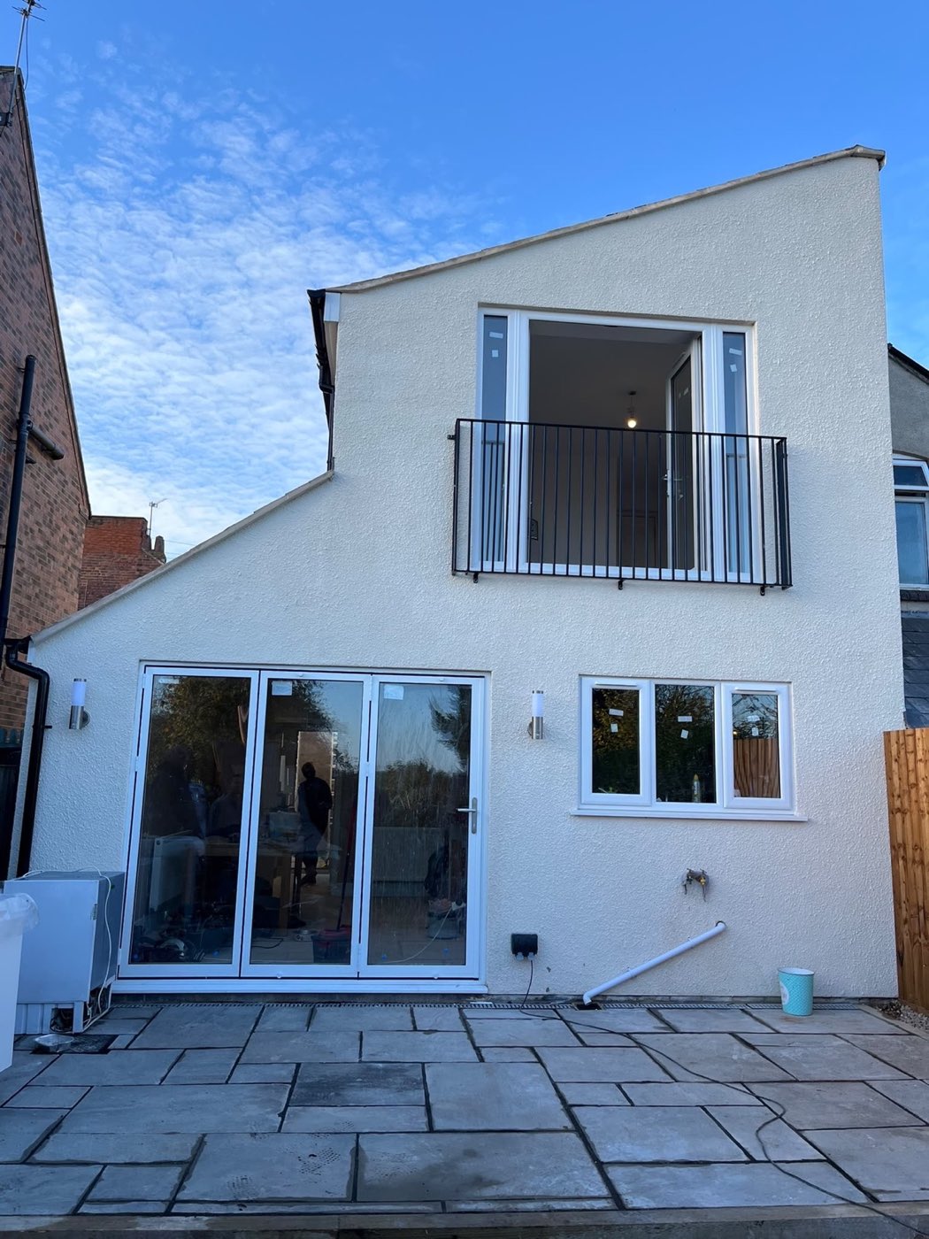 Rendered rear extension with bifold doors and a Juliet balcony