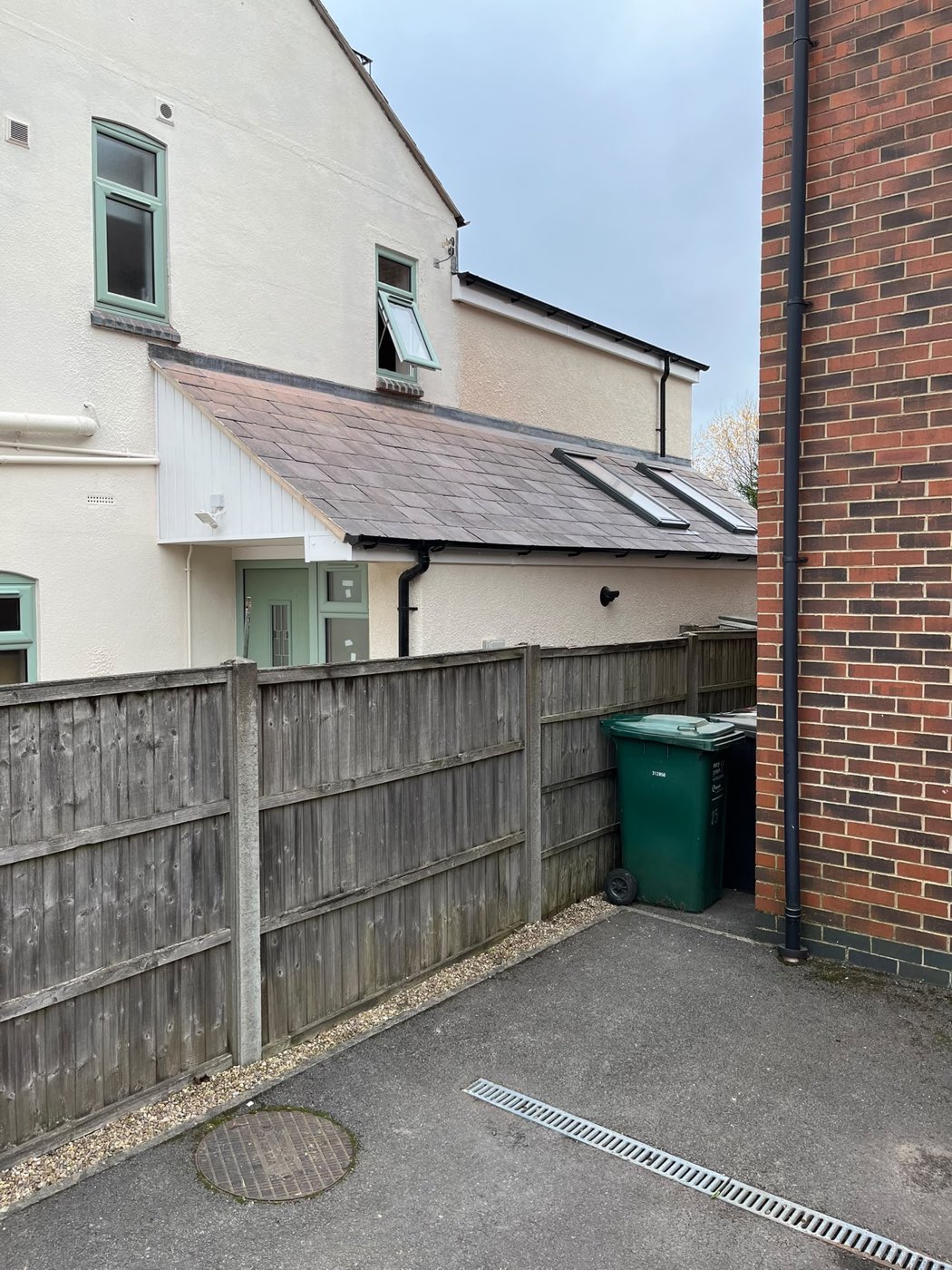 Guttering, downpipe and fascias along a rear roofline